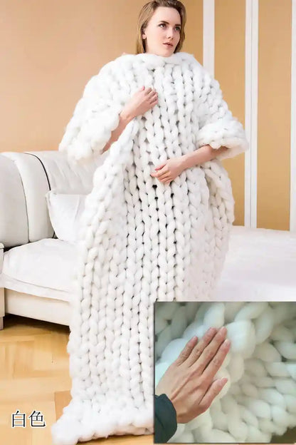 White chunky knit blanket wrapped around person