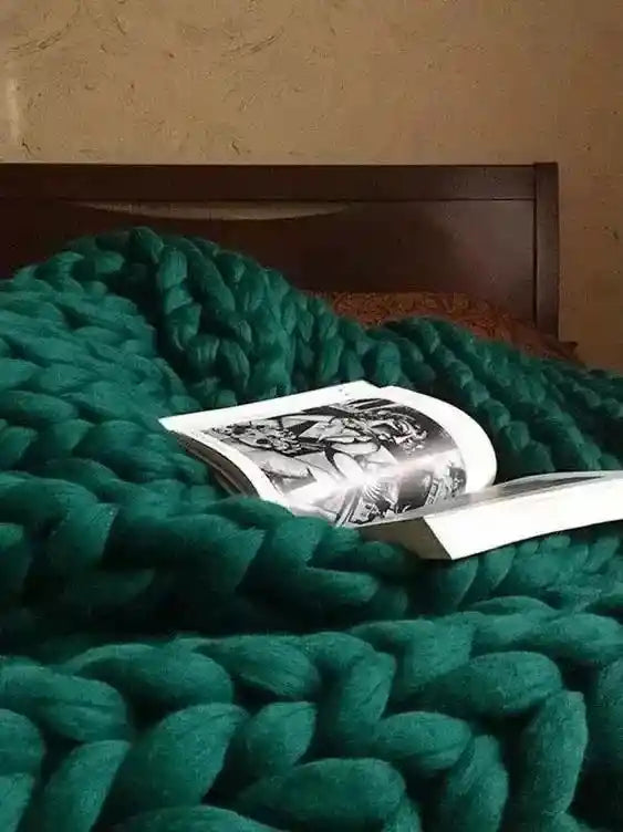 Green chunky knit blanket with open book